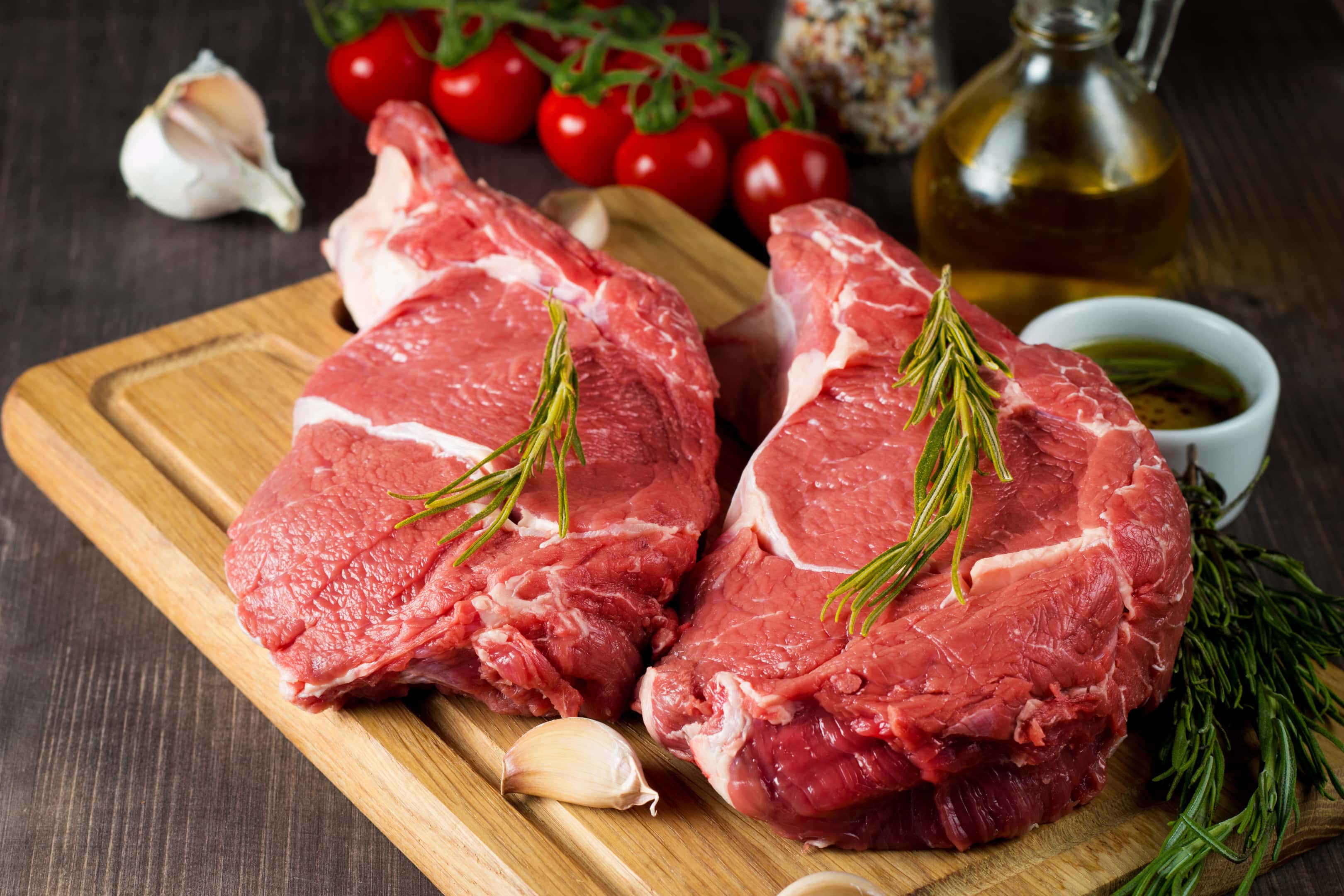 Raw Fresh Red Meat With Rosemary On Wooden Board