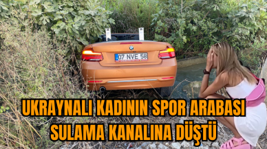 Ukraynalı kadının spor arabası sulama kanalına düştü