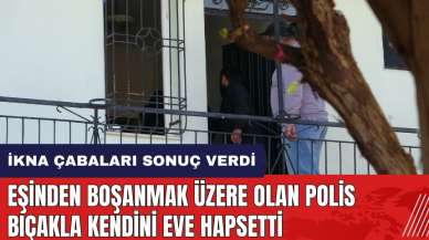 Eşinden boşanmak üzere olan polis bıçakla kendini eve hapsetti