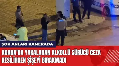 Adana'da yakalanan alkollü sürücü ceza kesilirken şişeyi bırakmadı